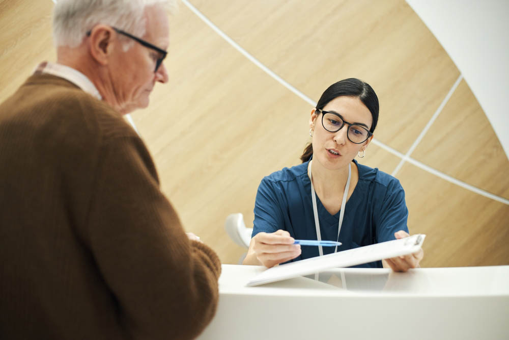 biofeedback patient talking to front desk personnel