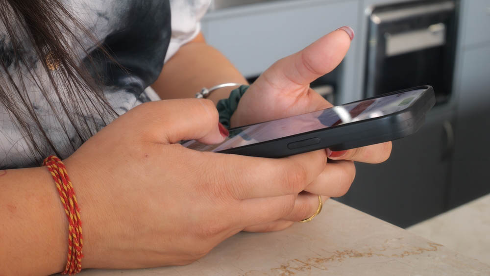 close-up of a person’s hands holding a smartphone
