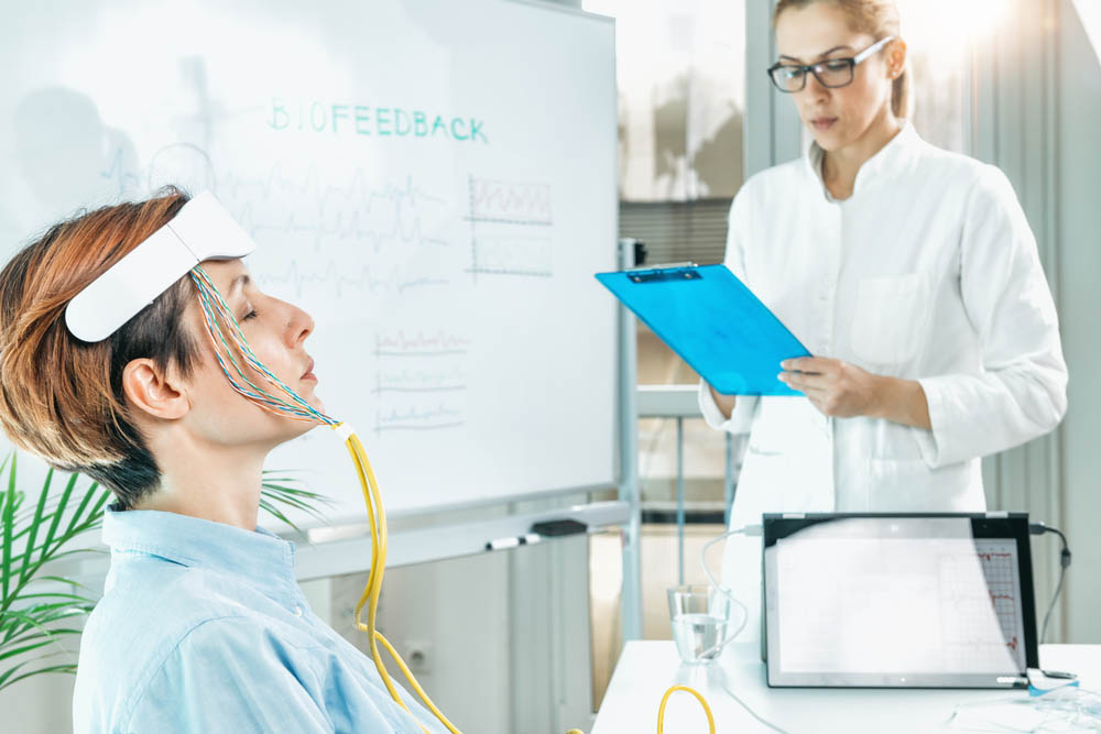 patient hooked up to biofeedback therapy equipmen